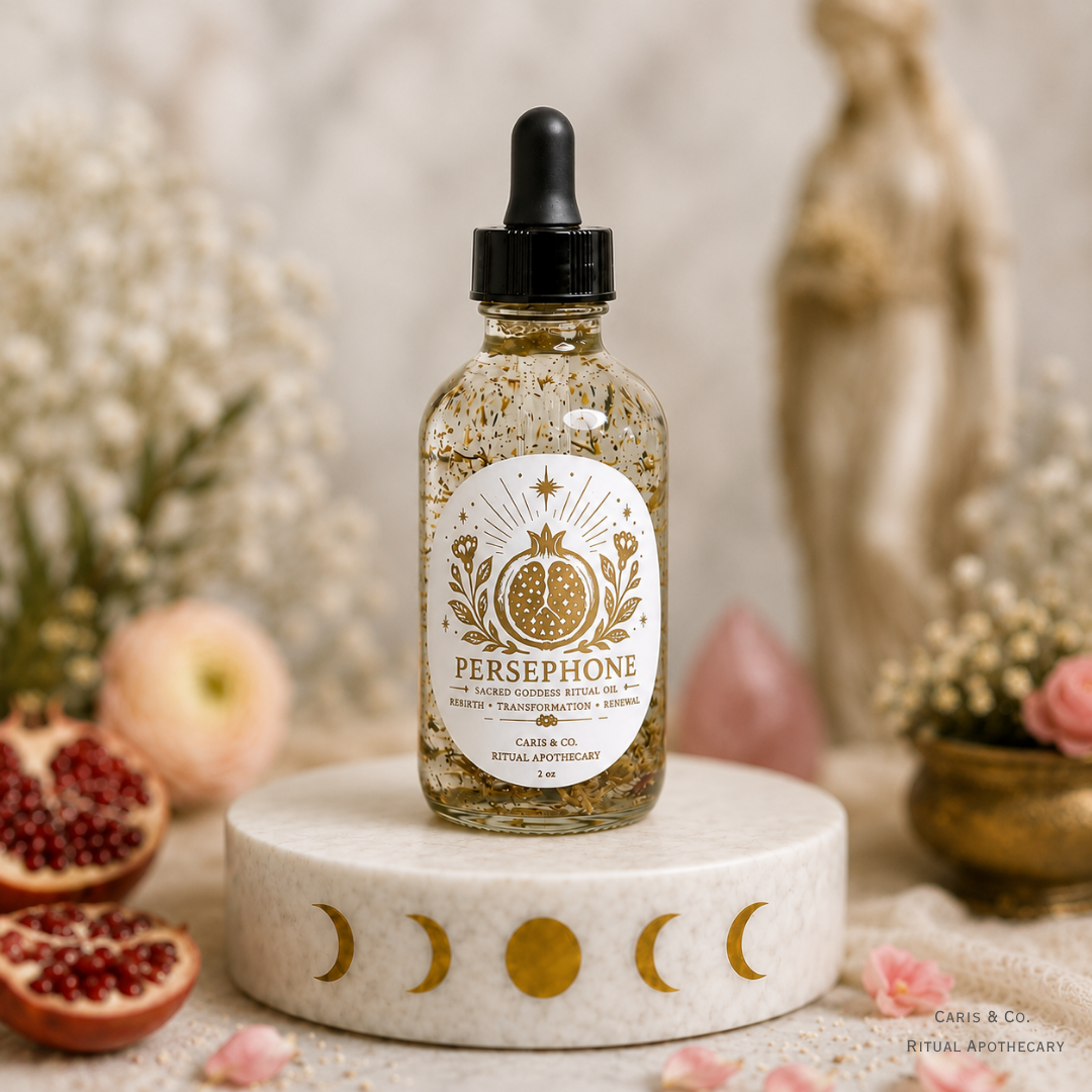 A glass dropper bottle of Persephone Ritual oil by Caris & Co. Ritual Apothecary  sits centered on a white stone pedestal with moon symbols. The bottle contains a golden glittery liquid and is surrounded by decorative props including pomegranates, dried flowers, and a statue in a softly lit, mystical setting.